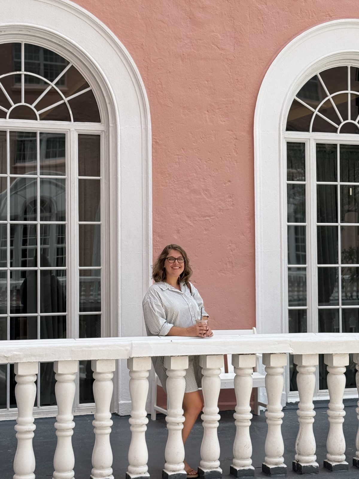 Kate at the pink hotel balcony